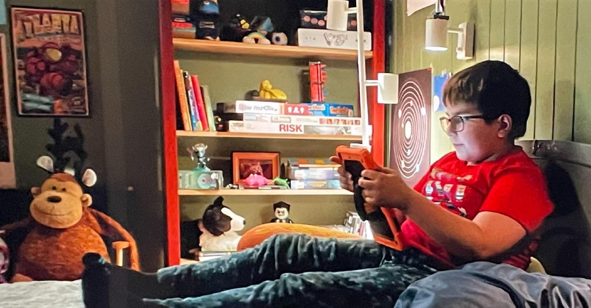 The Lenz-designed poster, featuring the 2023 Atlanta Science Festival design, appears in the Dear Santa film on the bedroom wall of character Liam Turner.