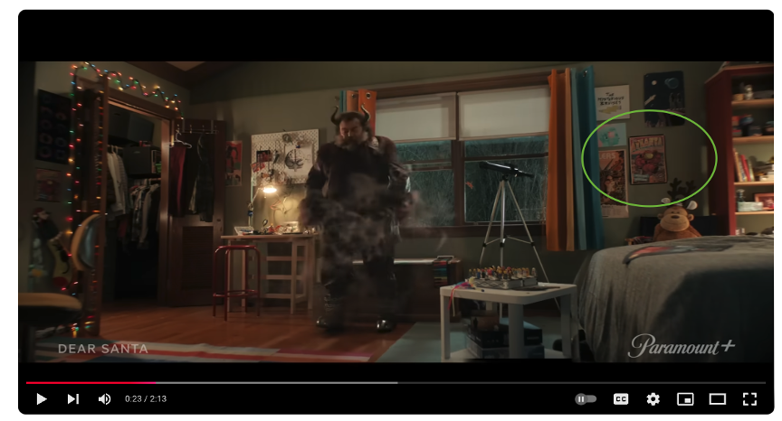 Screenshot of the Dear Santa movie trailer on YouTube, with a circle highlighting the Lenz-designed 2023 Atlanta Science Festival poster in Liam Turner's bedroom.